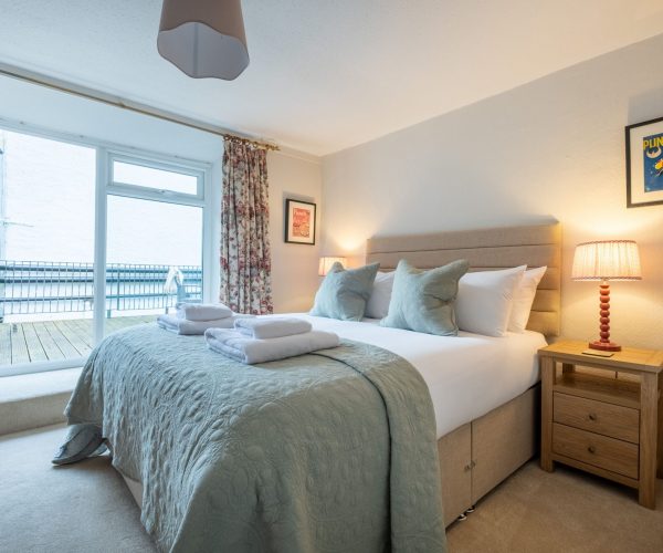 A peaceful nightâ€™s sleep awaits in the master bedroom of this dog-friendly Bowness cottage.