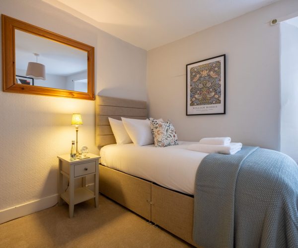 A charming second bedroom for guests at this dog-friendly Bowness cottage with parking.