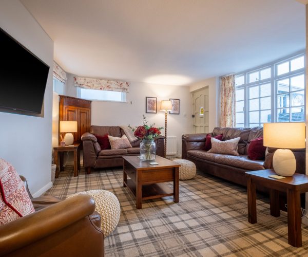 A bright, comfortable lounge with Smart TV media wall â€“ perfect for relaxing after a day on Lake Windermere.