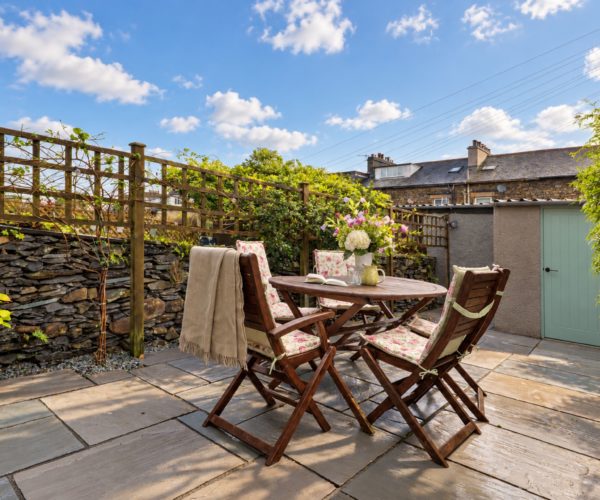 Charming rear courtyard with outdoor seating at Cornflower Cottage in Windermere
