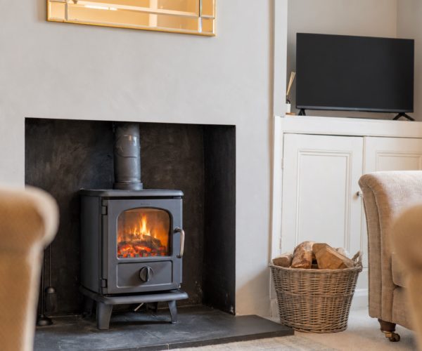 Cosy fireside seating in this characterful dog friendly Windermere holiday cottage