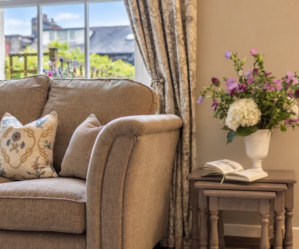 Spacious living room with comfortable seating for six guests at Cornflower Cottage